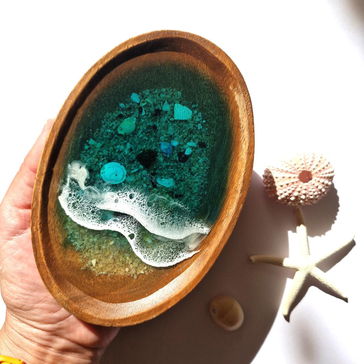 wooden oval dish with ocean resin art on a white background