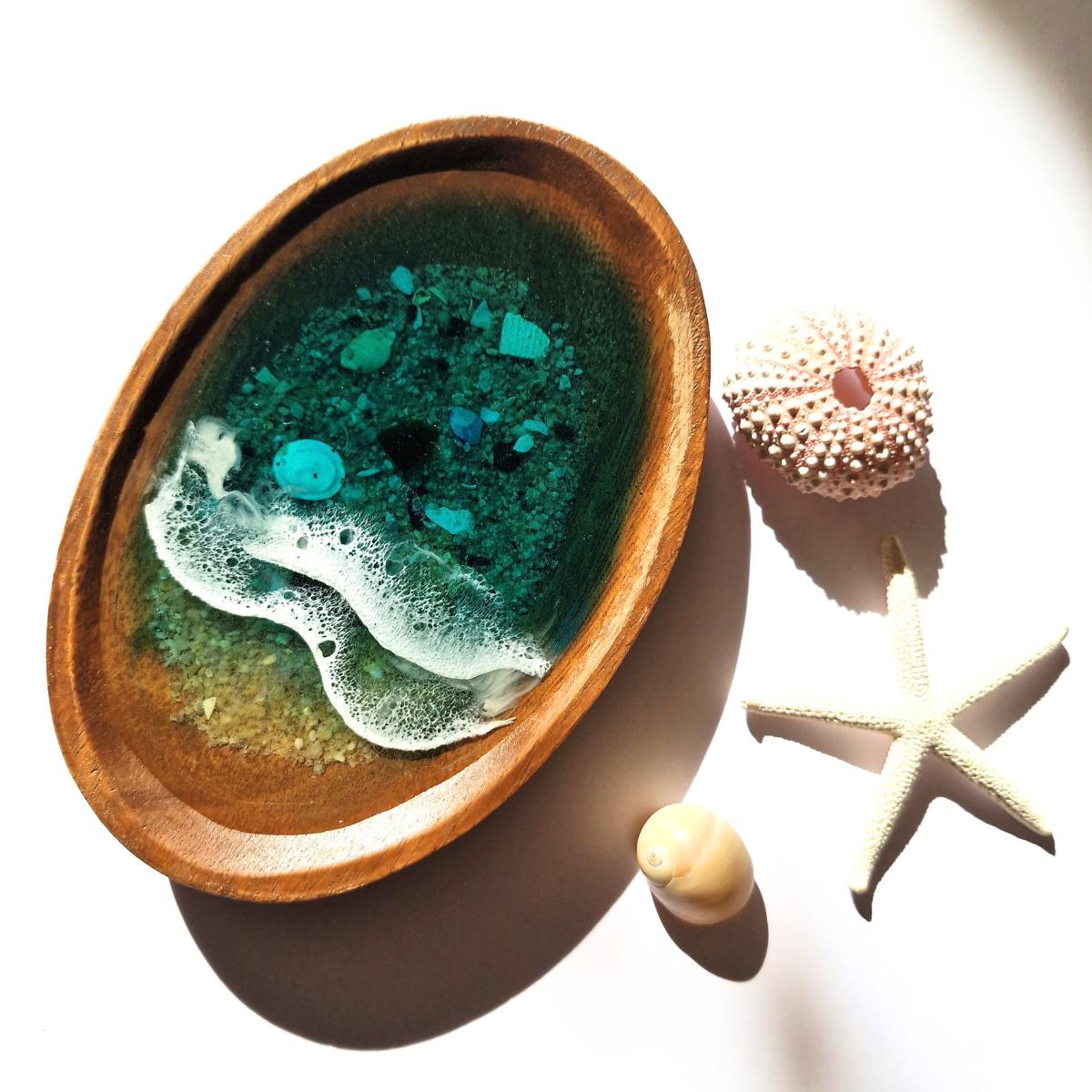 wooden oval dish with ocean resin art on a white background