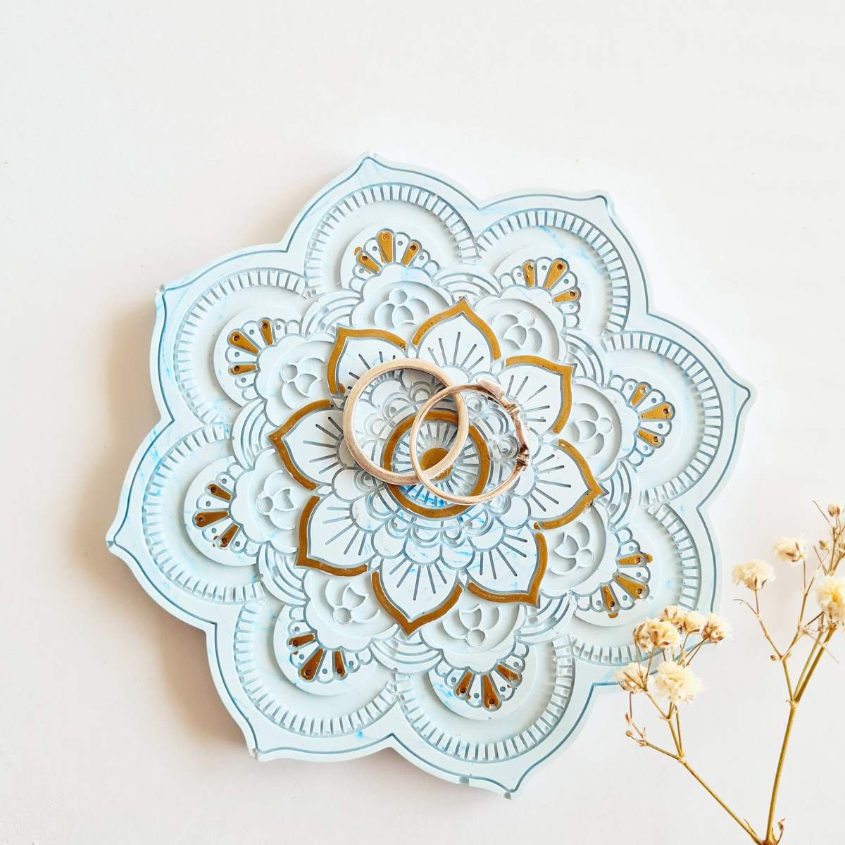 Flower shape blue and gold mandala ring dish/ coaster with rings on it