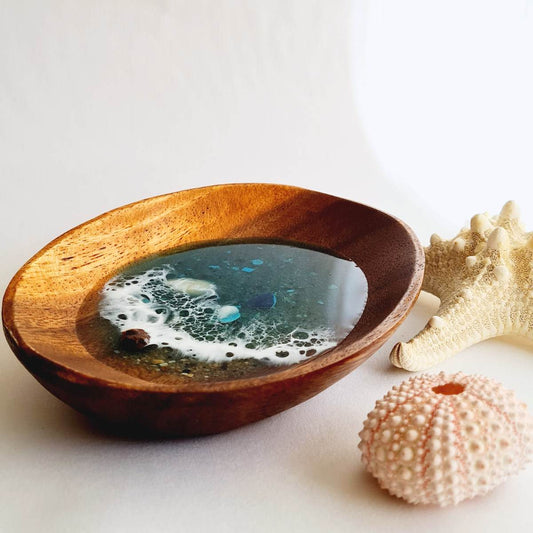 a wooden jewellery dish with resin ocean art on a white background