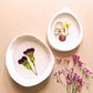 two white resin dishes with pressed flowers 