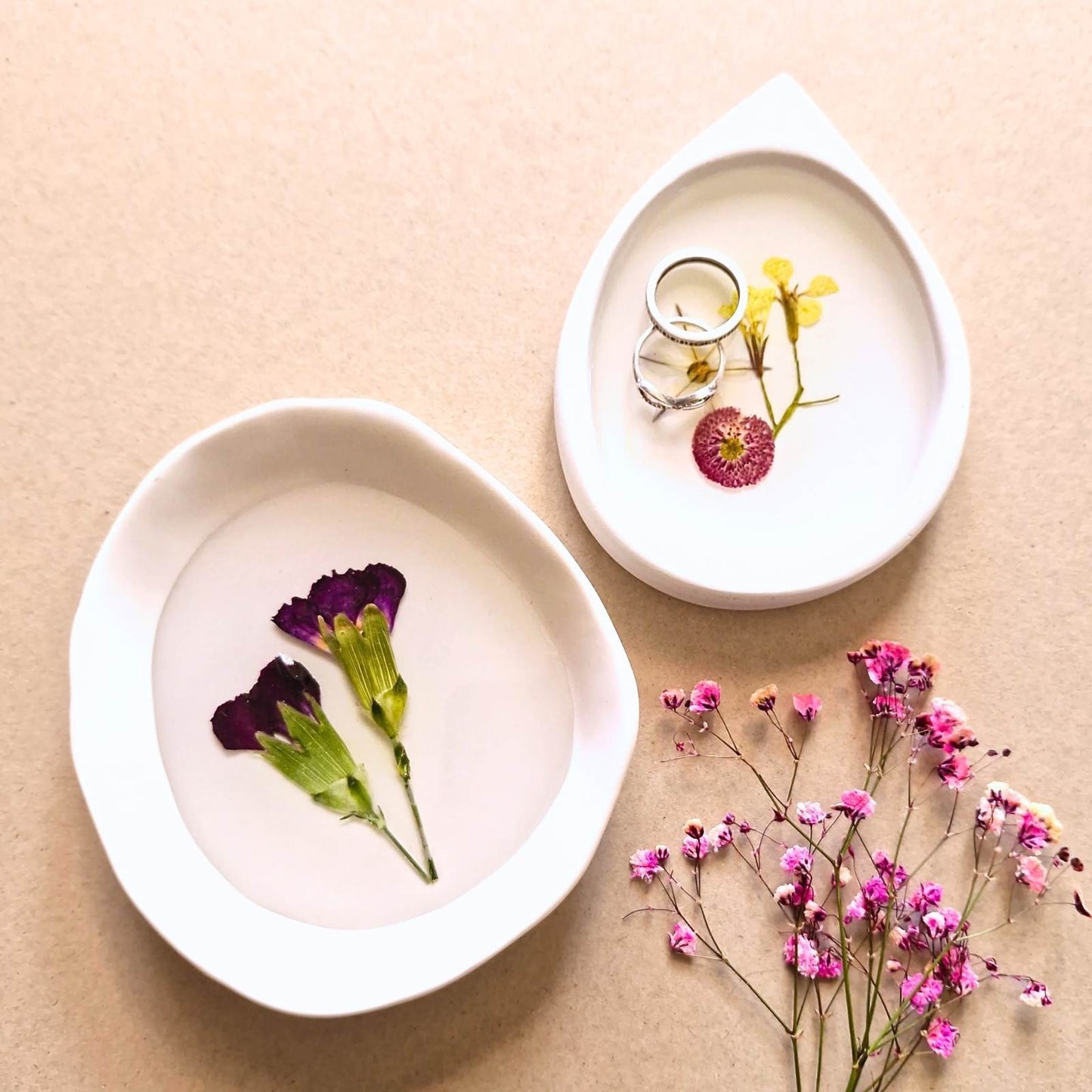 two white resin dishes with pressed flowers 