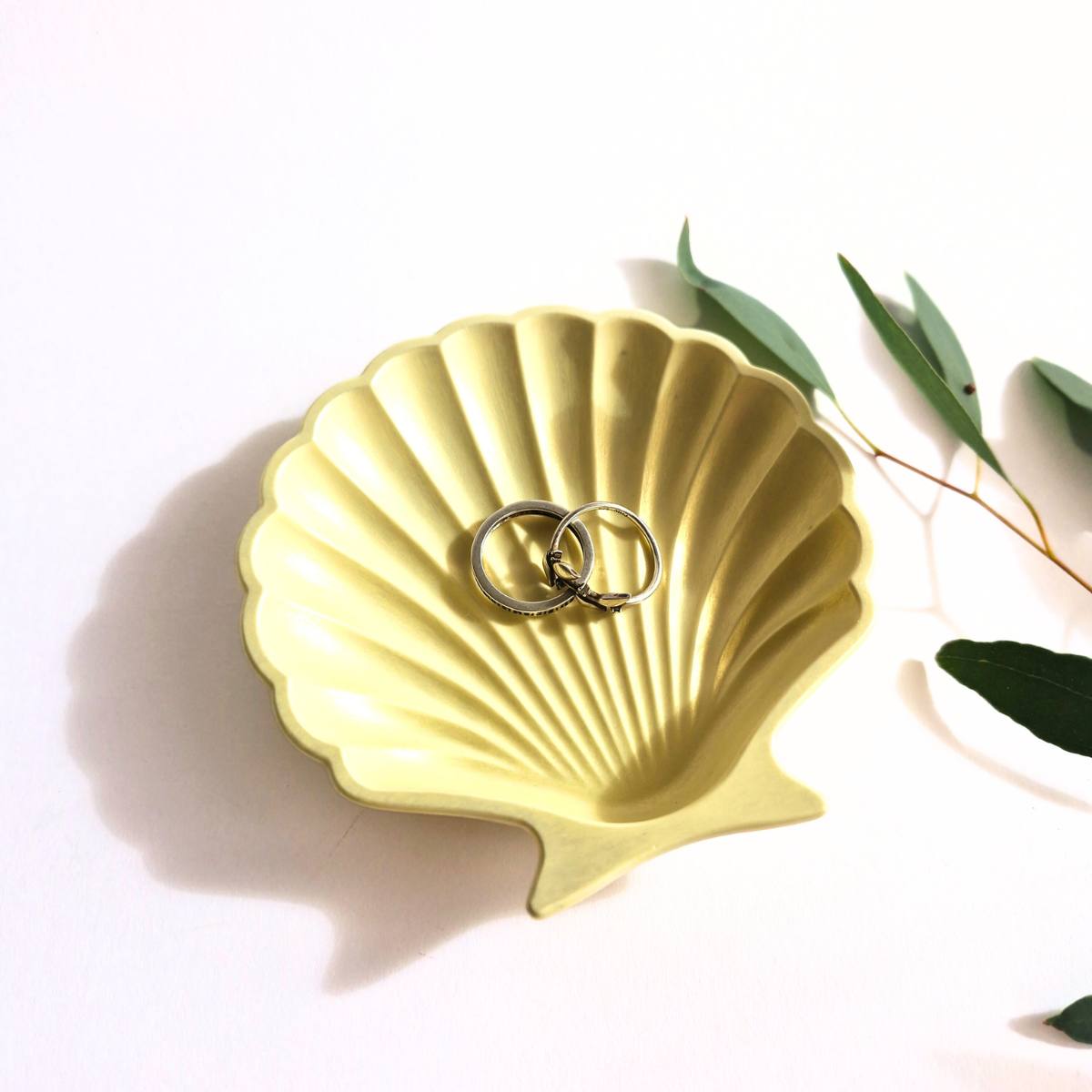 a yellow shell trinket dish